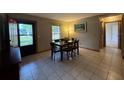 Inviting dining room with a wood table, tile floors, and a bright window at 1805 Ne 29Th Pl, Ocala, FL 34479