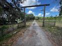 Long private driveway leads to a gated entrance, providing security and seclusion at 18130 Keene Rd, Altoona, FL 32702