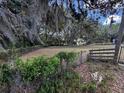 Spacious property with lush greenery, fencing, mature trees, and a peaceful, secluded atmosphere at 18130 Keene Rd, Altoona, FL 32702