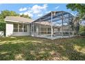 Backyard view of the large screened-in pool area providing a perfect outdoor living space at 1860 Park Forest Blvd, Mount Dora, FL 32757