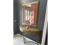 Elegant entryway featuring a console table with a beautiful framed floral artwork above it at 1875 Oxford Ln, The Villages, FL 32162