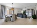 Bright living and dining area with neutral tile flooring, stylish furnishings, and sliding glass doors for natural light at 2012 Braxton St, Clermont, FL 34711