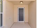 Inviting front entryway featuring a modern door, neutral walls, and a textured floor at 2026 Altamonte Way, The Villages, FL 32162