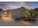 Beautiful exterior view of a single-story home featuring well-maintained landscaping and a private two-car garage at 2026 Altamonte Way, The Villages, FL 32162