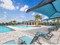 Resort-style pool featuring sun loungers and a covered picnic area at 2048 Airedale Way, Lake Alfred, FL 33850