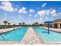 Community pool with a splashpad and plenty of seating at 2048 Airedale Way, Lake Alfred, FL 33850