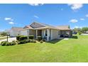 Lovely home with a screened-in lanai, perfect for outdoor entertaining and enjoying the backyard at 2104 Iveywood St, The Villages, FL 32163