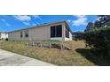 Spacious backyard featuring a screened-in porch and a pool area, perfect for relaxation at 2129 Amor Way, Leesburg, FL 34748