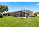 This home has a large, well-maintained backyard with a screened-in patio, perfect for outdoor relaxation at 25524 Maurepas Ln, Leesburg, FL 34748