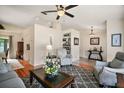Inviting living room featuring hardwood floors, a ceiling fan, and neutral color palette at 27022 Racquet Cir, Leesburg, FL 34748