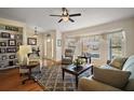 Cozy living room with natural light, comfortable seating, and stylish decor at 27022 Racquet Cir, Leesburg, FL 34748