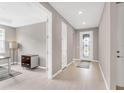 Open-concept foyer with light wood-look flooring and neutral paint, leading to an office and other living spaces at 2786 Top Hill Ct, Minneola, FL 34715