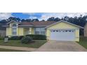 Charming single-story home featuring a well-maintained lawn and attached two-car garage at 2855 Picadilly Cir, Kissimmee, FL 34747