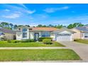 Charming one story home with a well manicured lawn, mature shrubbery and an attached two car garage at 2855 Picadilly Cir, Kissimmee, FL 34747