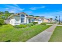 Well maintained home featuring a two-car garage, pristine lawn, and thoughtfully placed shrubbery at 2855 Picadilly Cir, Kissimmee, FL 34747