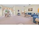 Inviting living room with a spacious layout, neutral paint, plush carpeting, and comfortable seating arrangements at 2855 Picadilly Cir, Kissimmee, FL 34747