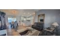Open-concept living room and kitchen area with stylish furnishings, decor, and updated lighting fixtures at 3096 Maywood Ct, The Villages, FL 32162
