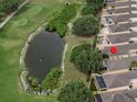 Beautiful aerial view of a home located next to a pond and golf course at 3325 Archer Ave, The Villages, FL 32162