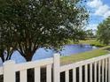 Scenic view of a pond from behind a white picket fence at 3325 Archer Ave, The Villages, FL 32162
