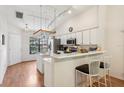 Bright kitchen features stainless steel appliances, center island, breakfast bar, and track lighting at 340 Juniper Way, Tavares, FL 32778