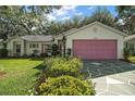 Attractive single-story home with a lush green lawn, mature landscaping and a unique, patterned driveway design at 4349 River Ridge Dr, Leesburg, FL 34748
