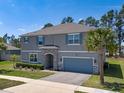 Two-story house with blue shutters, a stone-accented entrance, and a lush green lawn at 524 Avila Pl, Howey In The Hills, FL 34737