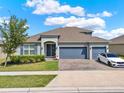 Beautiful single Gathering home with a three car garage, landscaped yard and curb appeal at 533 Avila Pl, Howey In The Hills, FL 34737