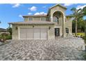 Inviting two-story home features a two-car garage and stone driveway at 54 Andora Ct, Kissimmee, FL 34758