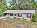 Charming single-story home with a well-maintained yard and purple trimmed windows at 706 Michigan St, Mount Dora, FL 32757