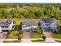 Aerial view of a gray home showcasing solar panels and landscaping in a suburban neighborhood at 769 Daybreak Pl, Longwood, FL 32750