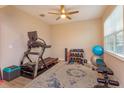 Exercise room features fitness equipment, a ceiling fan, and a window for natural light at 769 Daybreak Pl, Longwood, FL 32750