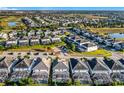 Overhead view of neighborhood featuring many single Gathering homes, screened in pools and lush landscaping at 9018 Stinger Dr, Davenport, FL 33896