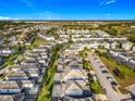Community aerial view showing lush landscaping, manicured lawns and single Gathering homes at 9018 Stinger Dr, Davenport, FL 33896