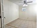 Bright room featuring tile floors, natural light, and ceiling fan at 104 N Oakland Ave, Clermont, FL 34715
