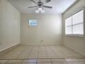 Bright room featuring tile floors, natural light, and ceiling fan at 104 N Oakland Ave, Clermont, FL 34715