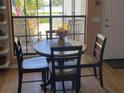 Cozy dining area with a round table and chairs, creating a warm and inviting space for meals at 106 Baytree Blvd, Tavares, FL 32778