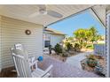 Comfortable front porch with rocking chairs, beautiful landscaping, and a serene setting at 106 Baytree Blvd, Tavares, FL 32778