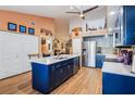 Modern kitchen featuring a large island, stainless steel appliances, and ample cabinet space at 106 Baytree Blvd, Tavares, FL 32778