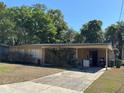Charming single-story home with attached carport and an inviting exterior at 1108 Oak Dr, Leesburg, FL 34748