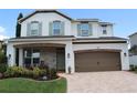 Charming two-story home with lush landscaping, brick accents, and a spacious two-car garage at 1281 Gatewood Ave, Minneola, FL 34715