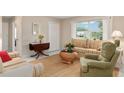 Cozy living room with a large window, comfortable seating, and neutral decor at 13050 Se 120Th St, Ocklawaha, FL 32179