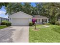 Charming single-story home with a well-manicured lawn, flowering shrub and inviting curb appeal at 1358 E Schwartz Blvd, The Villages, FL 32159