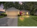 Charming one story home featuring a two car garage, inviting walkway and professionally landscaped yard at 1358 E Schwartz Blvd, The Villages, FL 32159