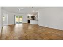 Spacious living room with sliding glass doors leading to the backyard at 1409 Gatlin Pl, The Villages, FL 32163