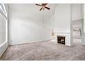 Bright living room with a fireplace, neutral carpet, high ceilings, and plenty of natural light at 1413 Silverthorn Dr, Orlando, FL 32825