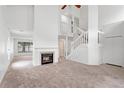 Spacious living room featuring a fireplace, staircase, neutral carpet, and lots of natural light at 1413 Silverthorn Dr, Orlando, FL 32825
