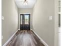 Light-filled foyer with wood-look flooring and a decorative front door that welcomes you inside at 155 W C-466, Lot # 1 W C 466, Oxford, FL 34484