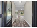 Inviting entryway featuring wood-look flooring and a clear view to the bright living space at 155 W C-466, Lot # 1 W C 466, Oxford, FL 34484