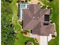 Aerial view of the home showing the roof, pool, solar panels, and landscaped yard at 17194 Se 85Th Willowick Cir, The Villages, FL 32162