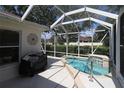 Enclosed pool features a spa and outdoor grill area, perfect for entertaining and relaxation at 17194 Se 85Th Willowick Cir, The Villages, FL 32162